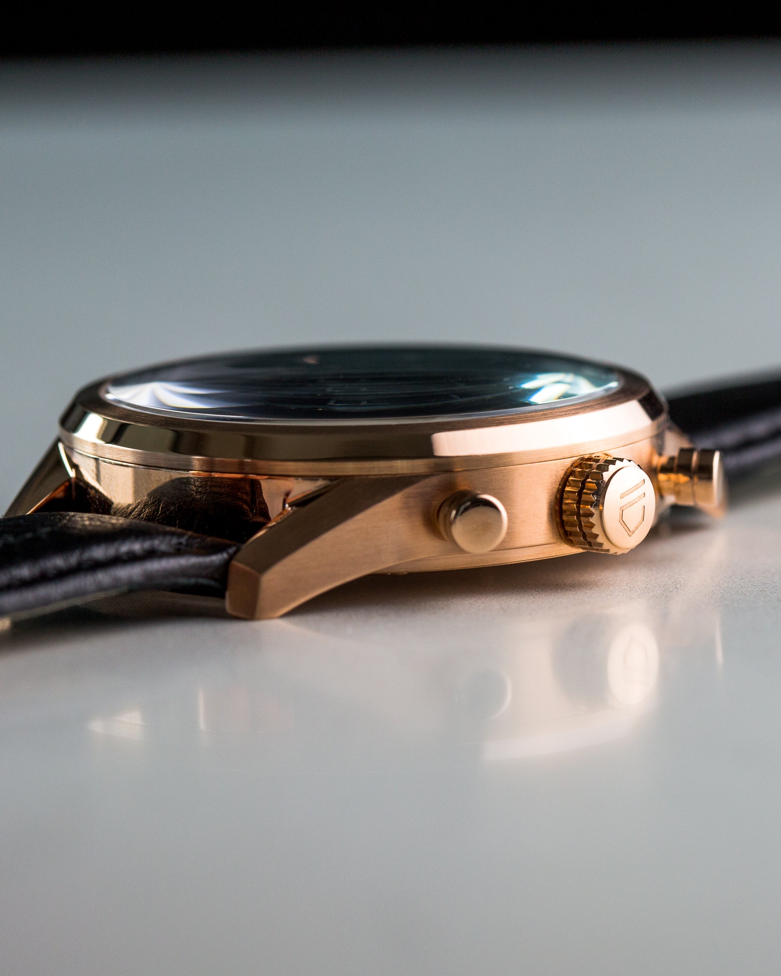 rose gold watch case showing crown with engraved logo